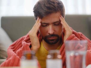 man-with-sinusitis-under-blanket-resting-at-home