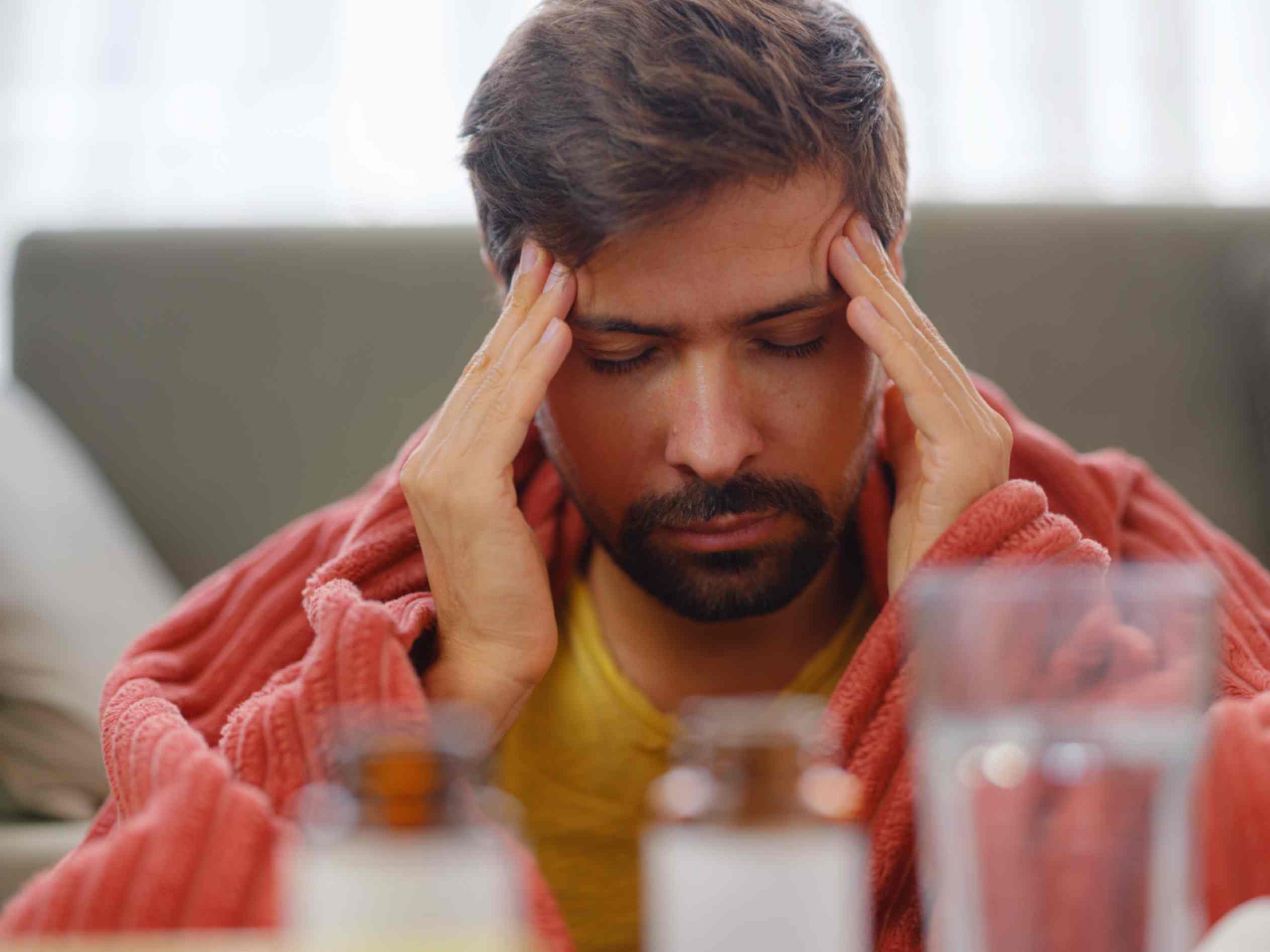 man-with-sinusitis-under-blanket-resting-at-home