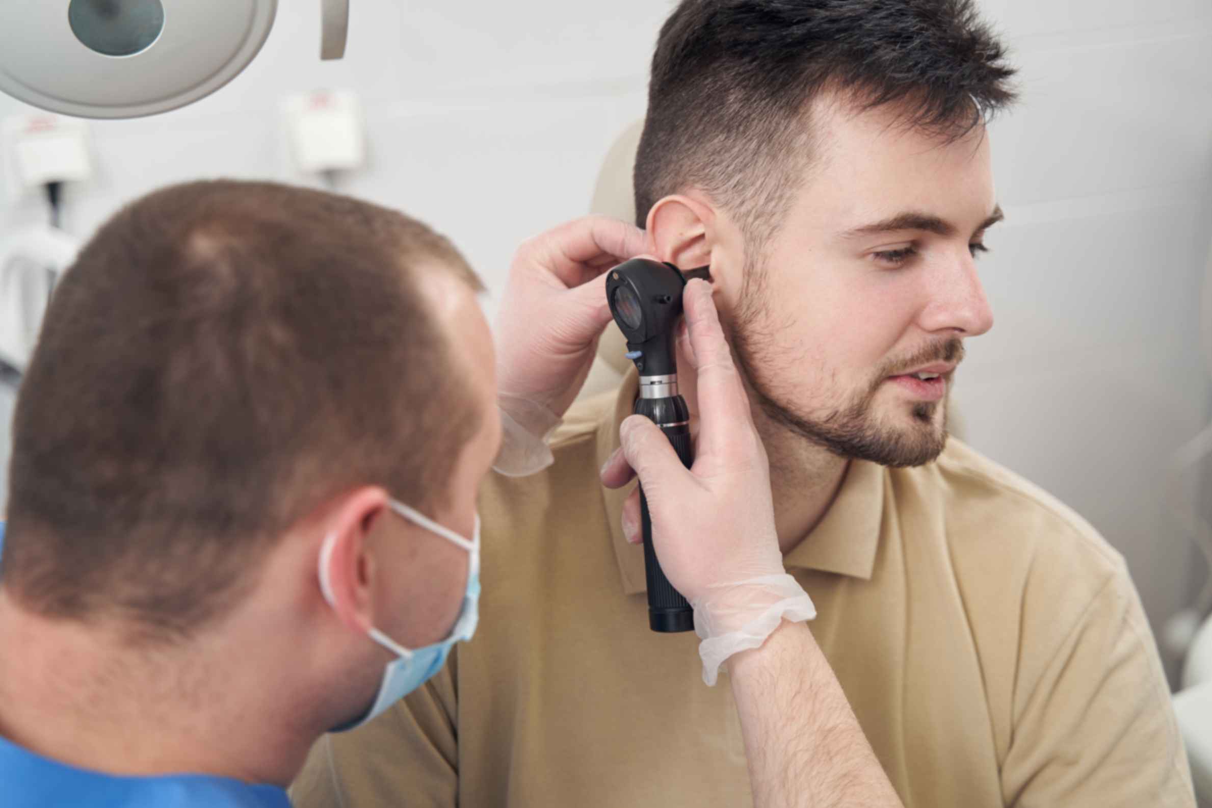adult-man-getting-his-ear-examined-by-doctor