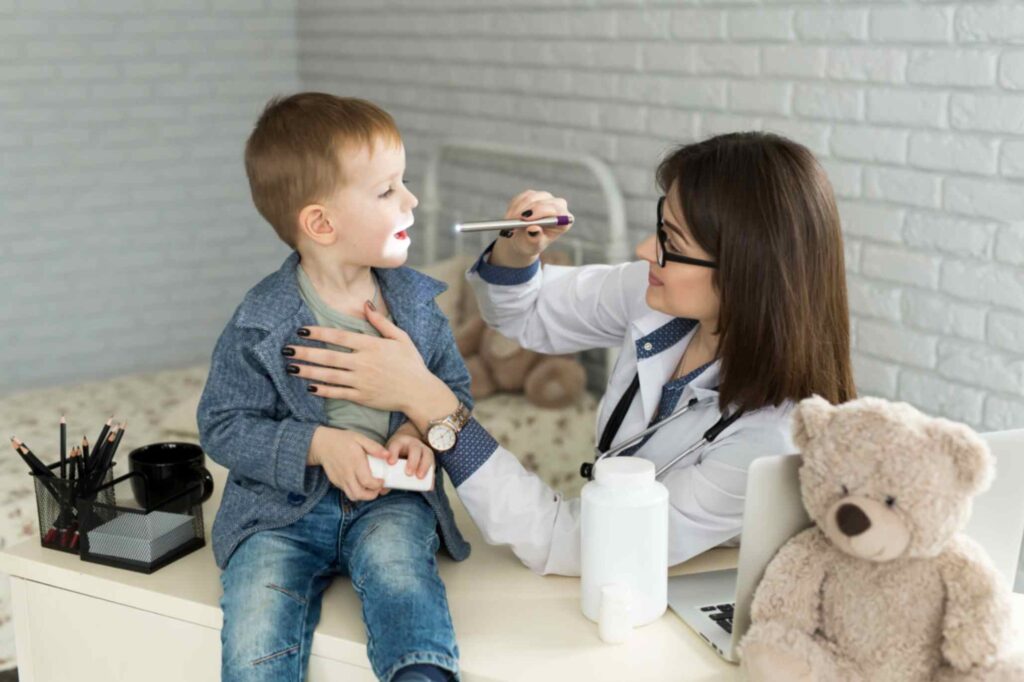 doctor-examine-child-s-throat-boy-at-minor-ailments-clinic