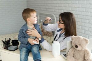 doctor-examine-child-s-throat-boy-at-minor-ailments-clinic