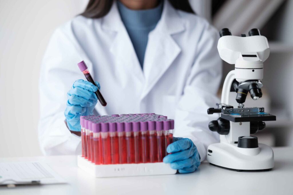 private-blood-test-lab-worker-examines-blood-samples-with-microscope