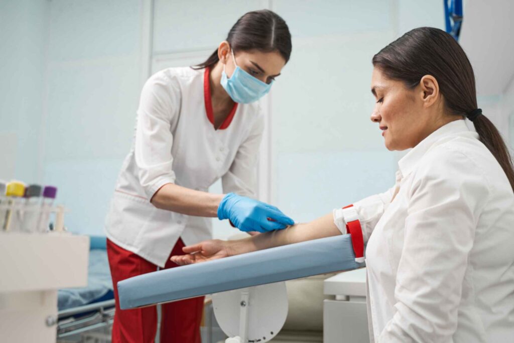 medical-professional-taking-blood-for-regular-blood-test-from-adult-patient