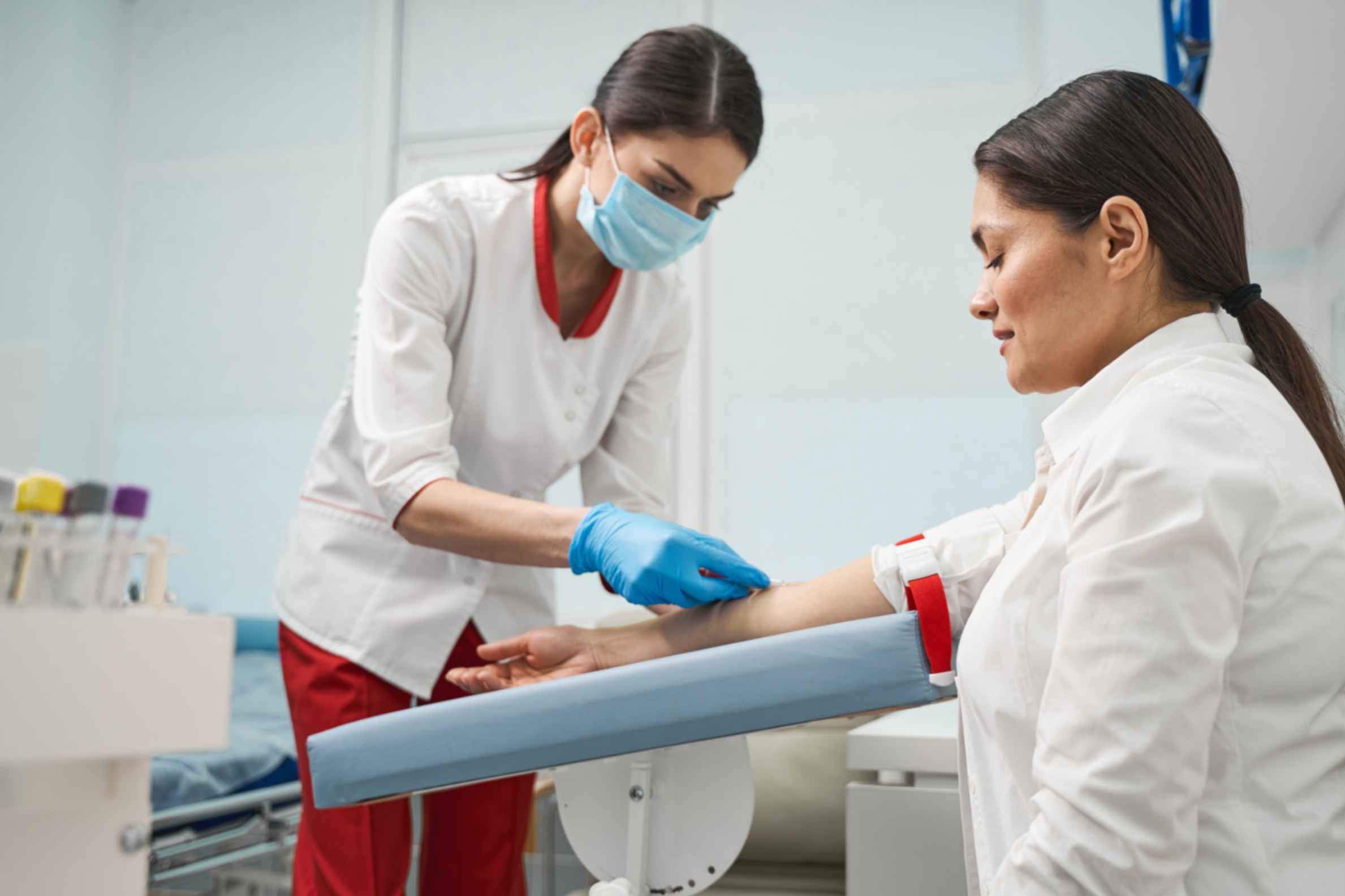 medical-professional-taking-blood-for-regular-blood-test-from-adult-patient